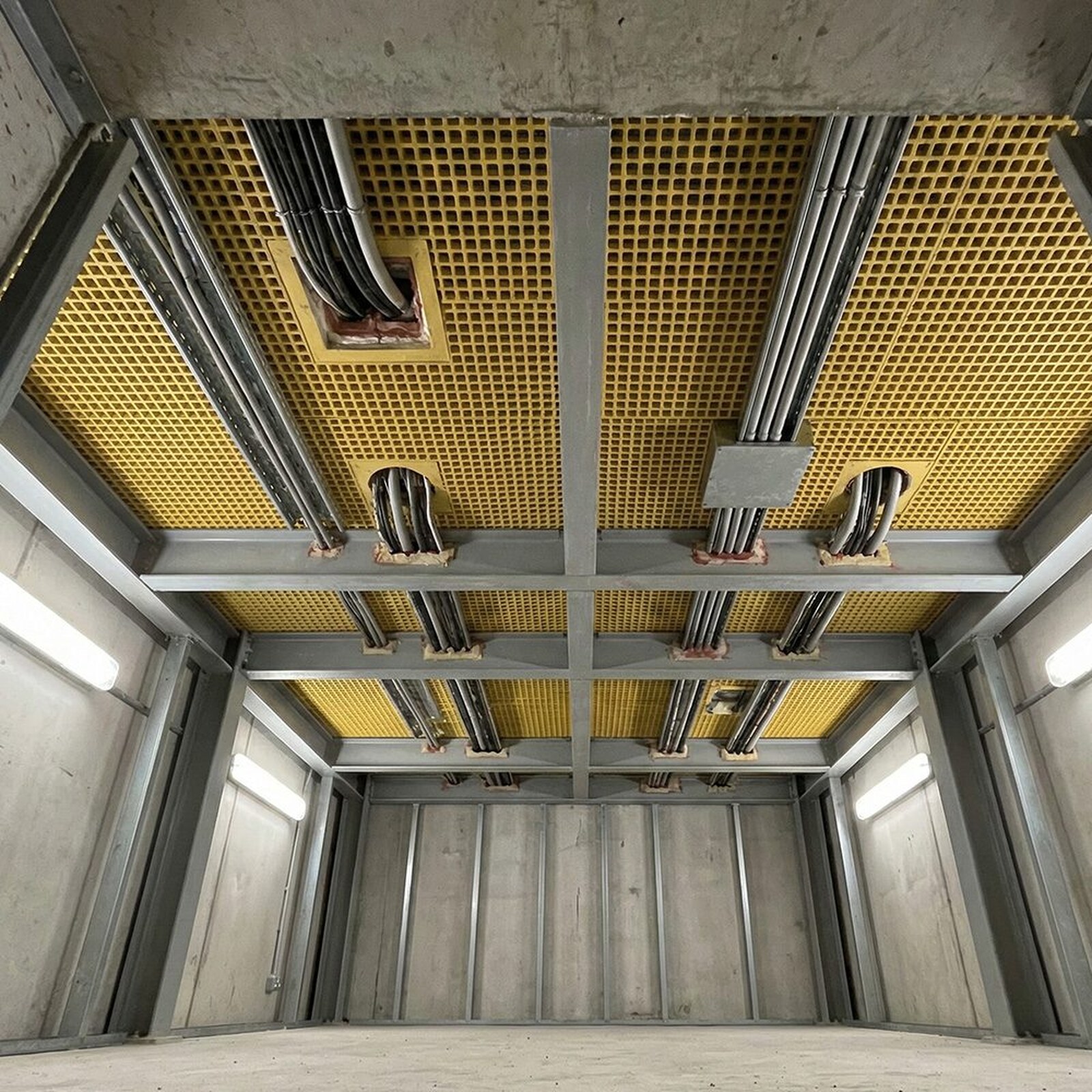 GRP grating panels seen from below, bearing on the support steelwork